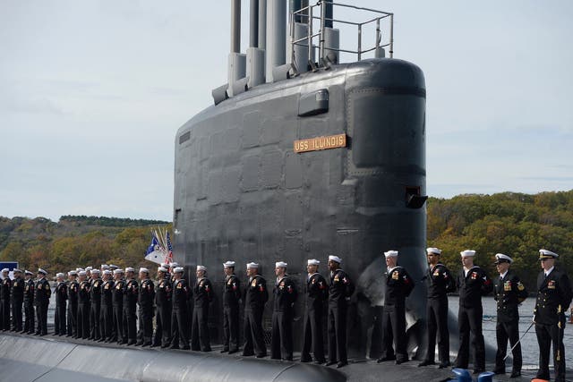 Sailors stand atop the USS Illinois in harbour at Groton, CT