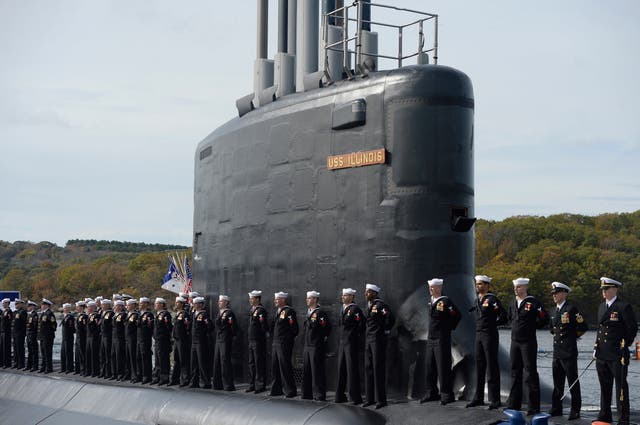 Sailors stand atop the USS Illinois in harbour at Groton, CT