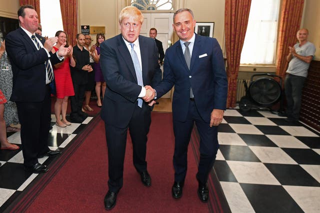Boris Johnson shakes hands with Mark Sedwill as the new prime minister is clapped into No 10 after winning the election last year