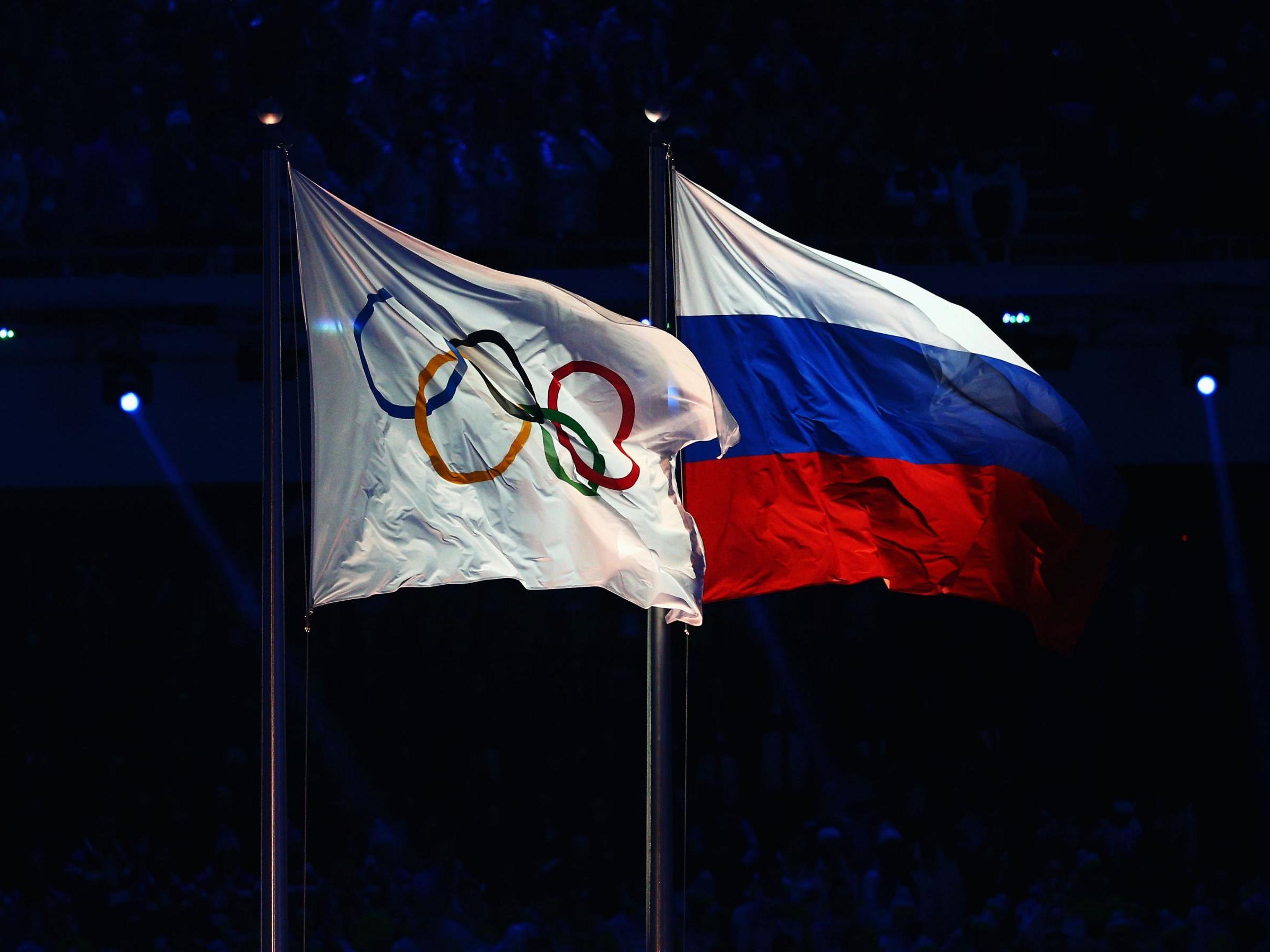 The Olympic flag flies next to the Russian flag