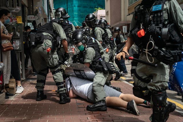 A man is detained by riot police in Hong Kong during a demonstration against the new law earlier this month