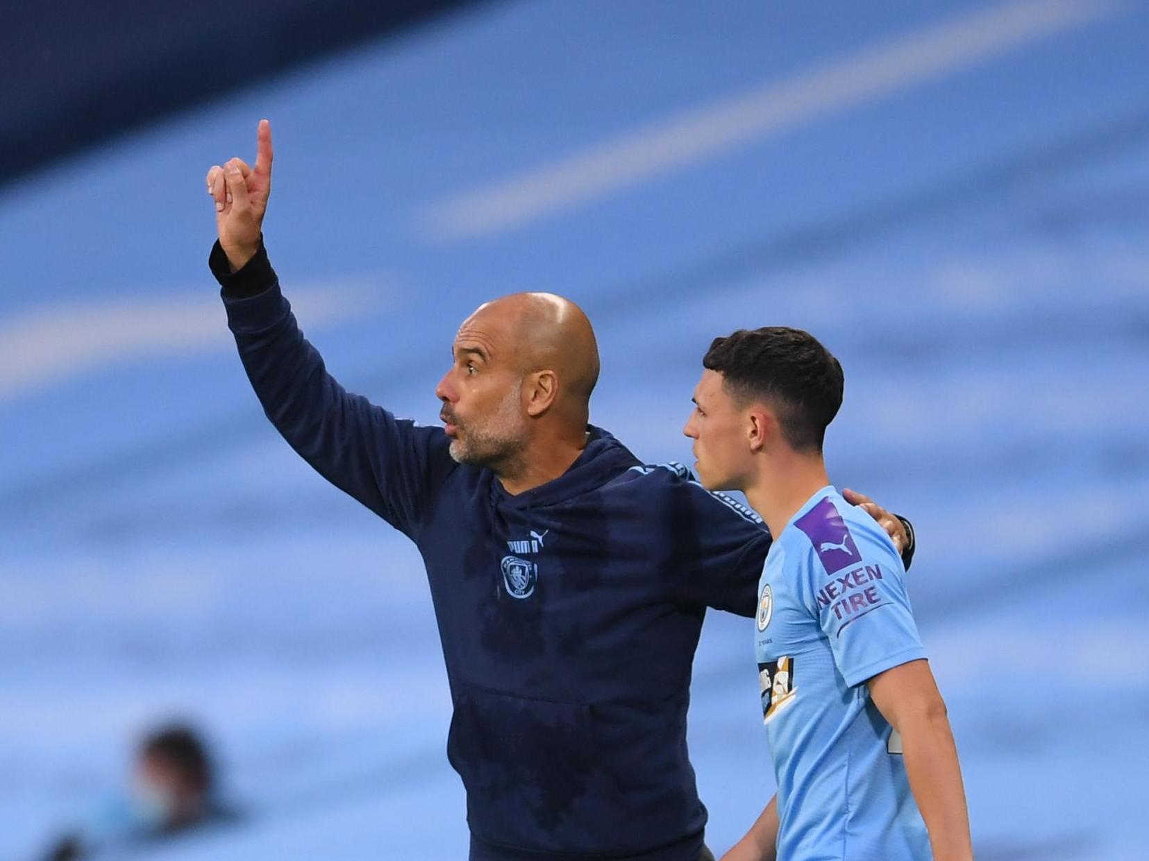 Man City manager Pep Guardiola (left) with Phil Foden