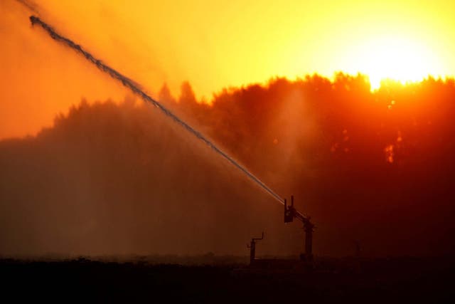 A field is irrigated during a heatwave in France last month. Heatwaves are lasting longer and happening more frequently around the world