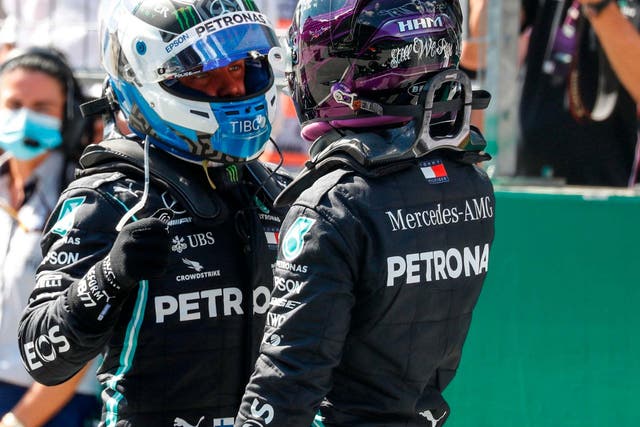 Valtteri Bottas is congratulated by Lewis Hamilton after taking pole position for the Austrian Grand Prix