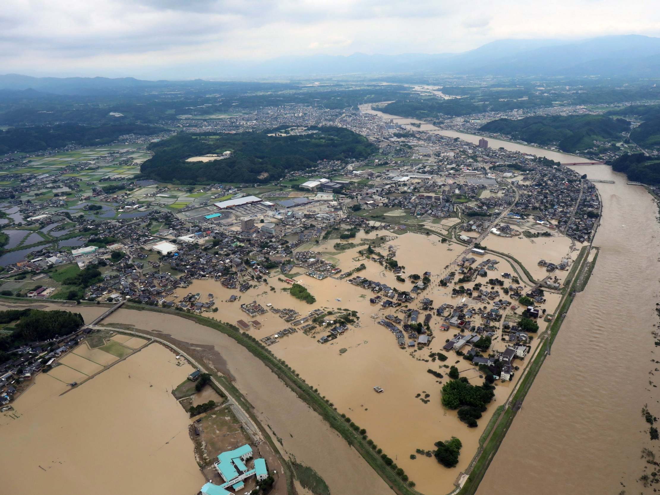 Japan floods: 'Unprecedented rainfall' leaves at least 15 dead and houses swept away amid devastating landslides