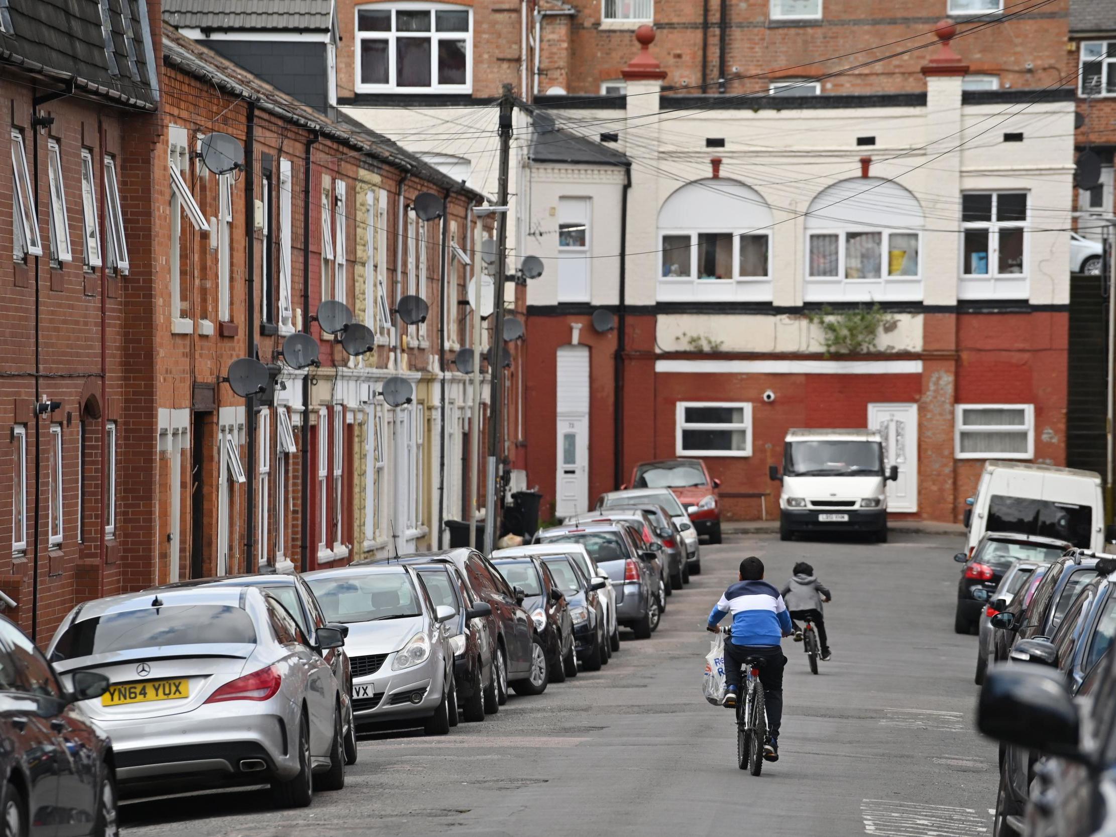 Children cycle in North Evington, one of the worst-hit areas of Leicester