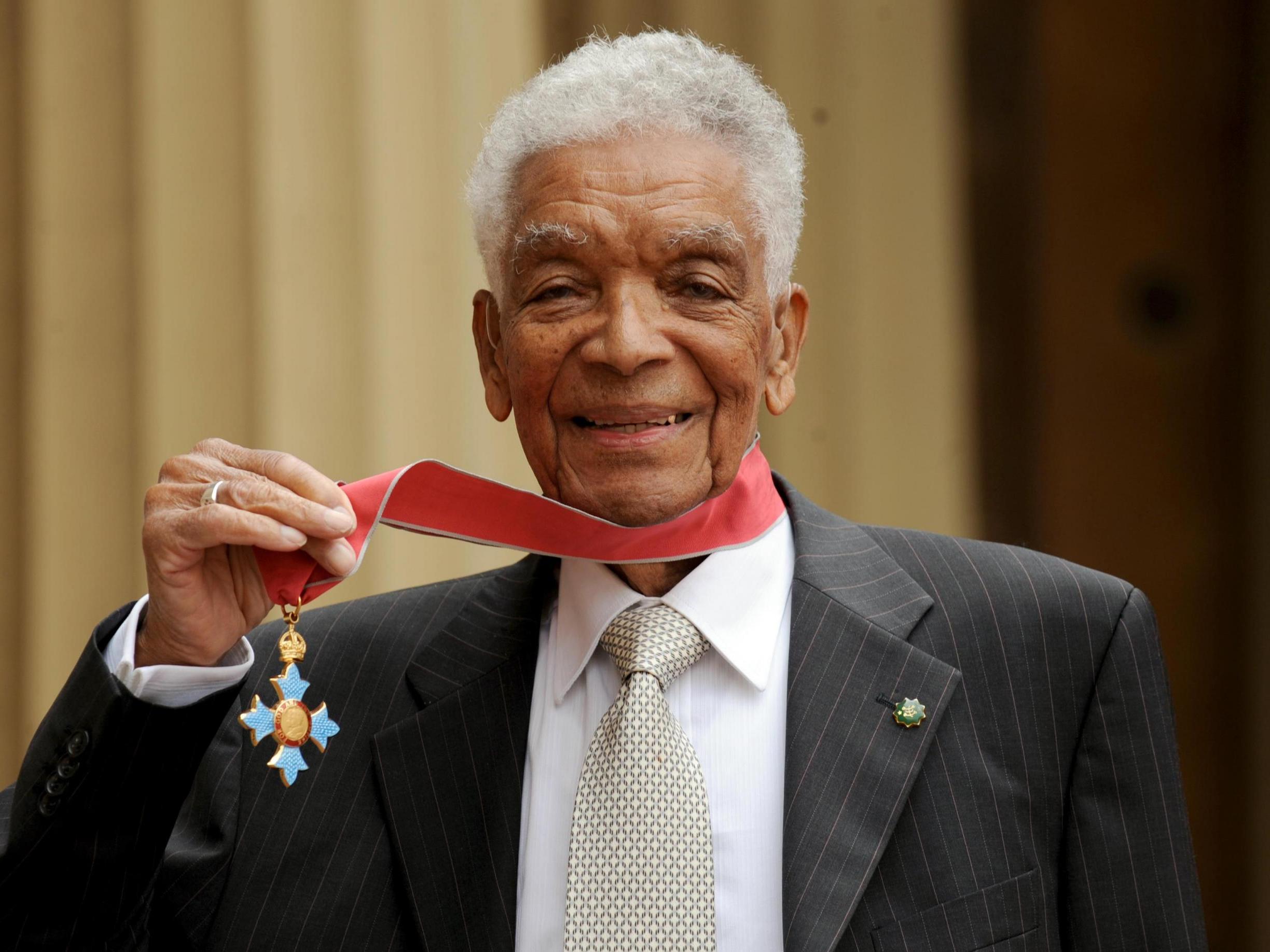 Earl Cameron outside Buckingham Palace with his CBE