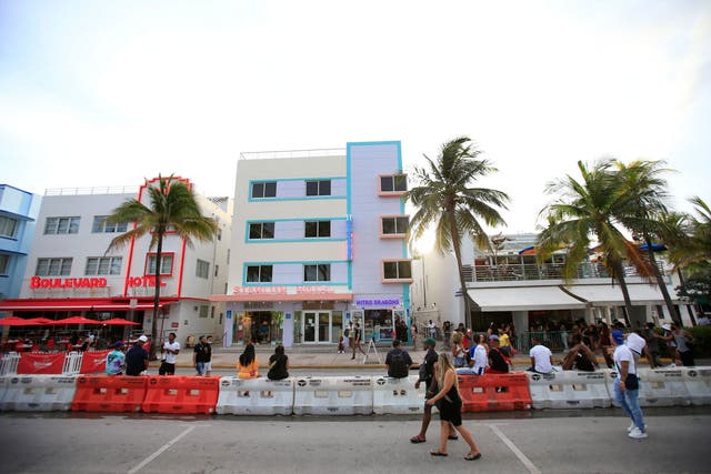 People gather on Ocean Drive on 3 July in the South Beach neighborhood of Miami Beach, Florida