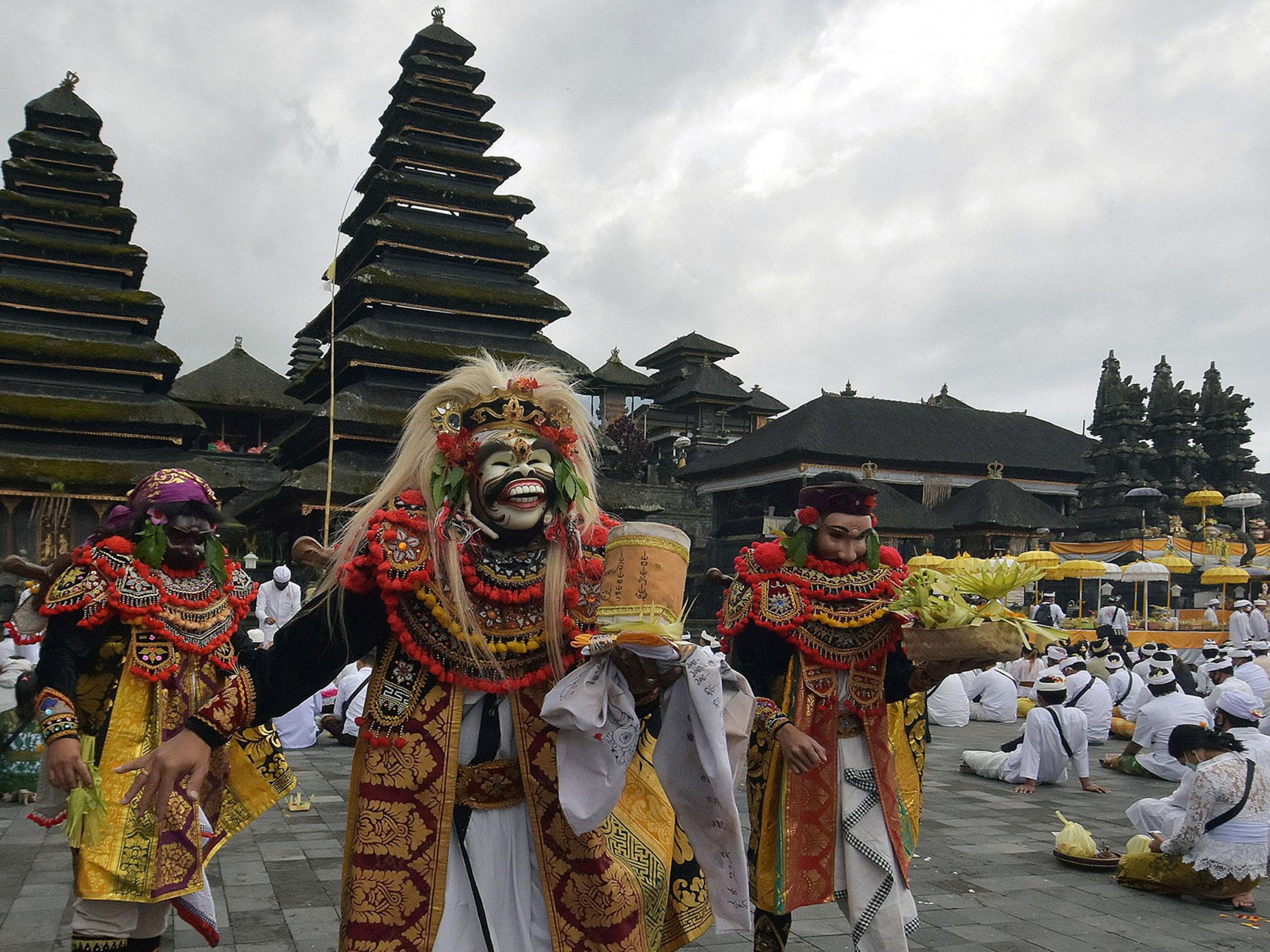 Artists perform Sidakarya mask dancing during mass prayers in Bali