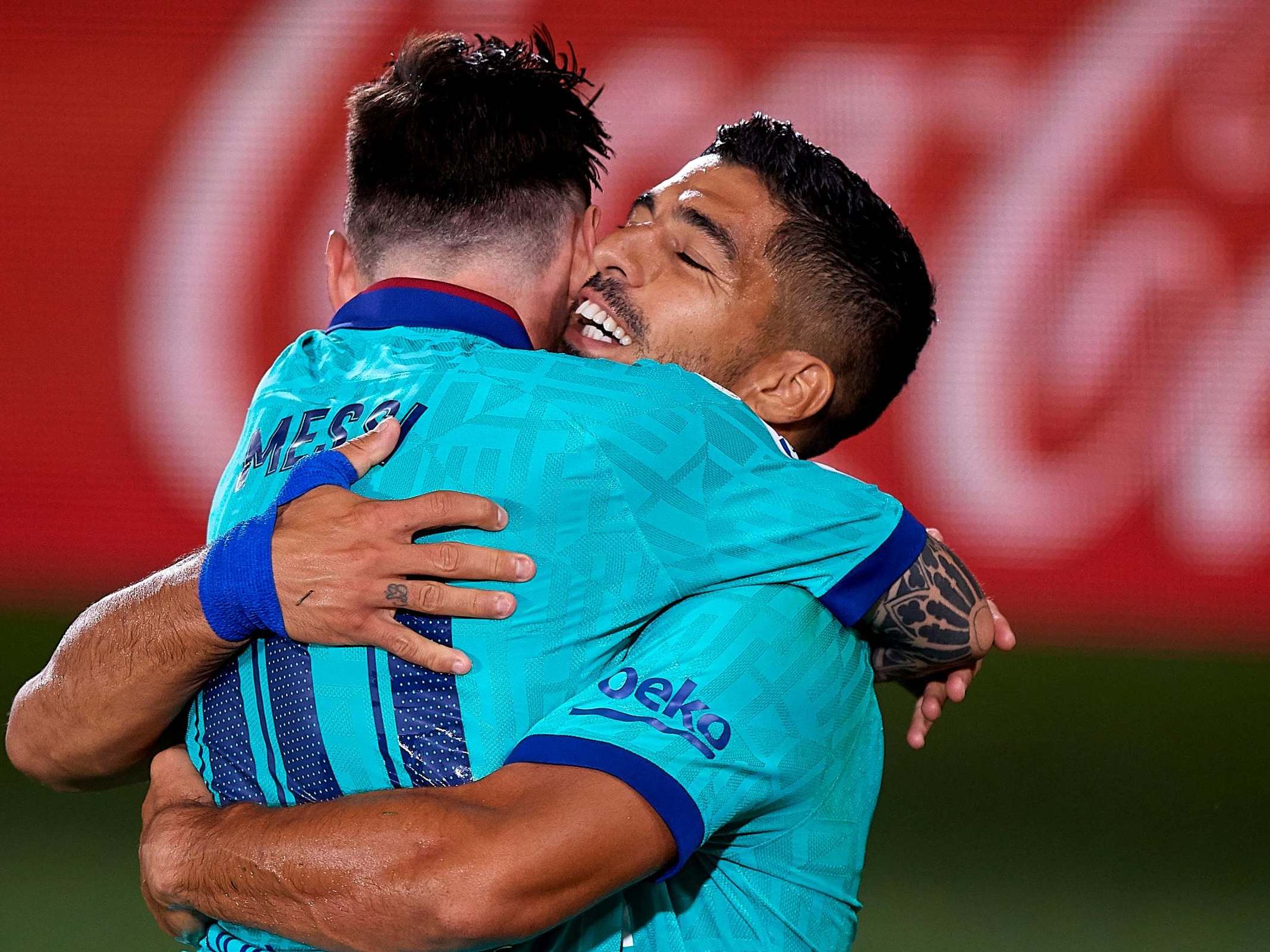 Lionel Messi celebrates with Luis Suarez during victory against Villarreal