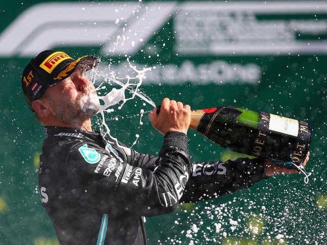 Mercedes' Finnish driver Valtteri Bottas celebrates with champagne