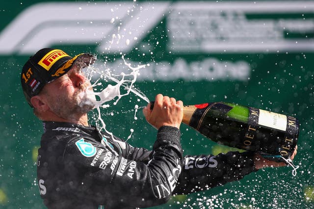 Mercedes' Finnish driver Valtteri Bottas celebrates with champagne