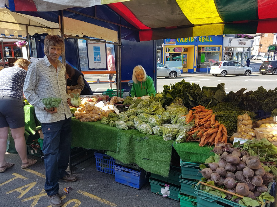 Roger at a farmers’ market in Mosely. He has used seasonal workers for more than 30 years