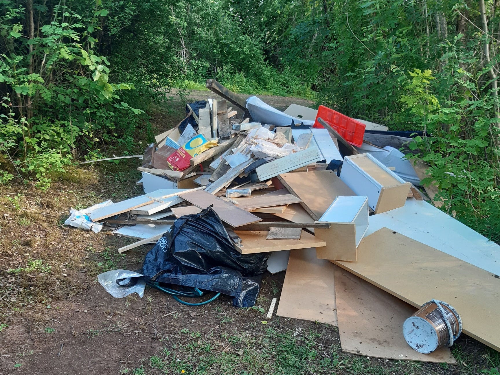 Fly-tipped debris in Barber Wood in Gloucester