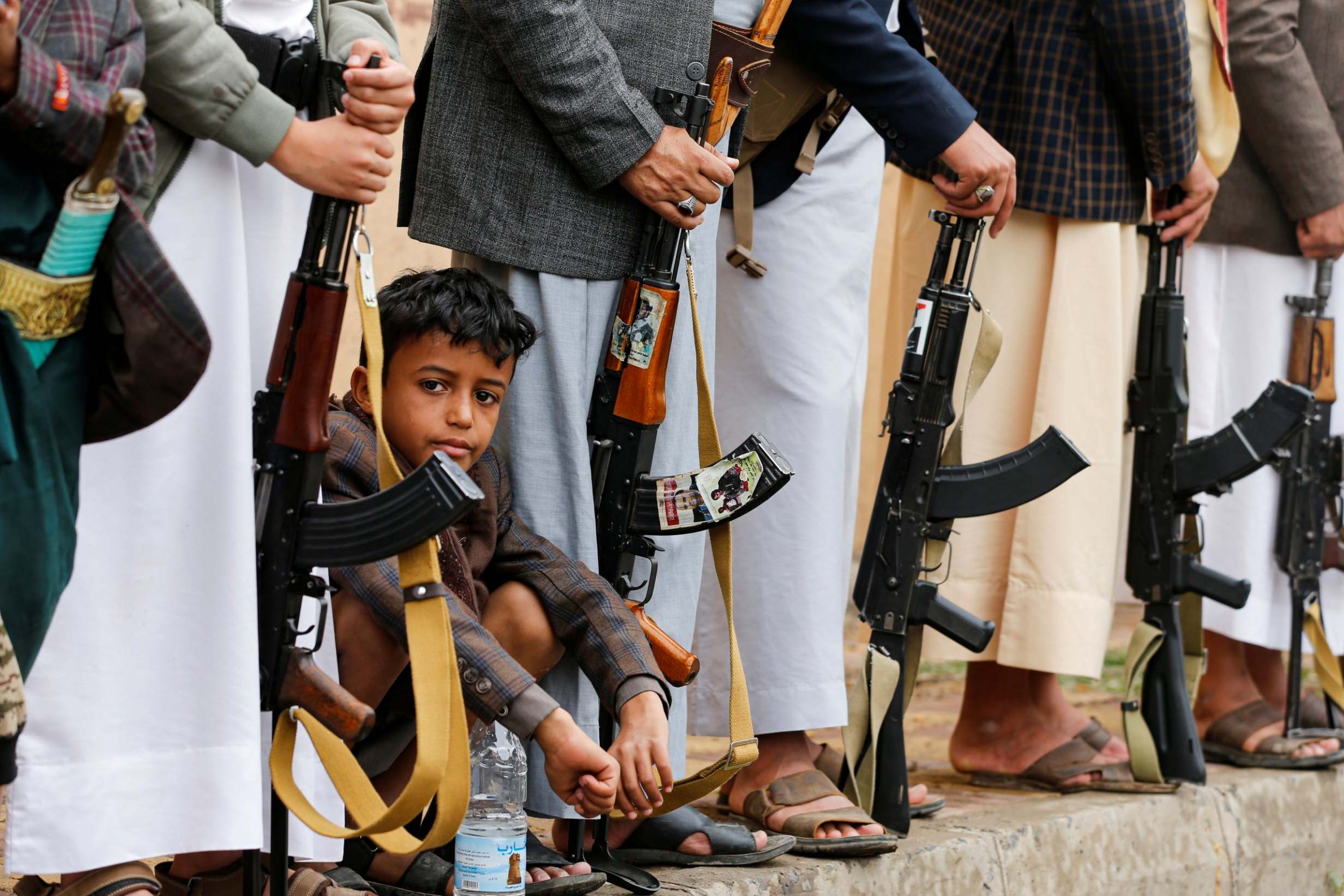A boy sits among Houthi followers during a gathering in Sanaa (Reuters)