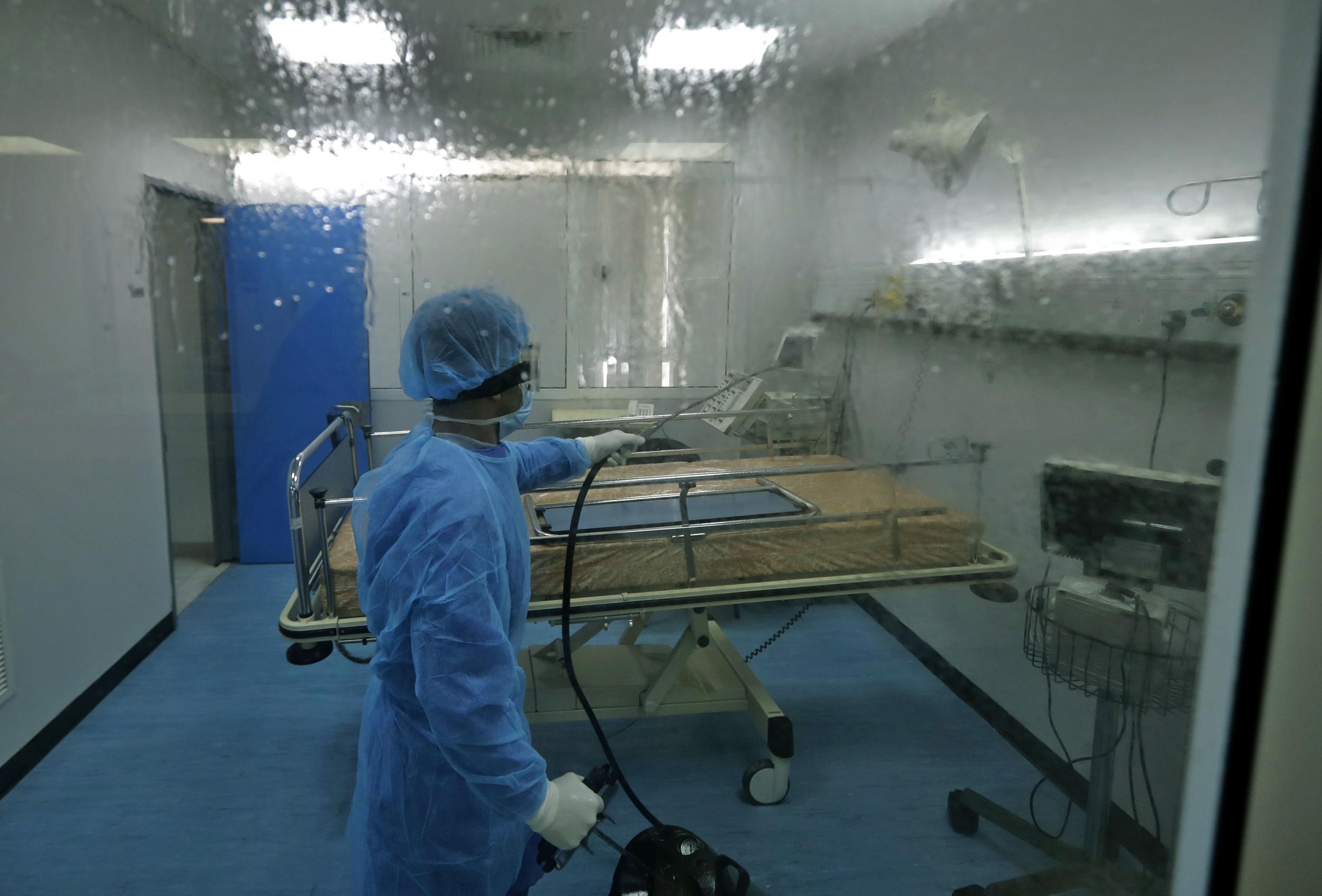 A man disinfects an intensive care isolation room at the Rafik Hariri public hospital in the Lebanese capital Beirut