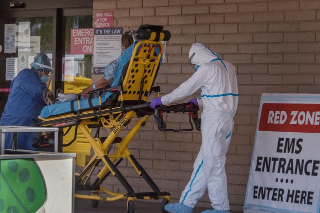 A patient is taken from an ambulance to the emergency room of a hospital in the Navajo Nation town of Tuba City during the 57-hour curfew, imposed to try to stop the spread of the Covid-19 virus