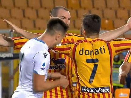 Patric appears to bite the left arm of Guilio Donati during Lazio's defeat by Lecce