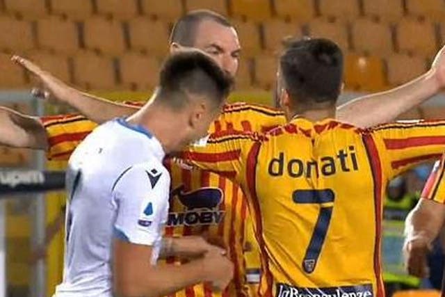 Patric appears to bite the left arm of Guilio Donati during Lazio's defeat by Lecce