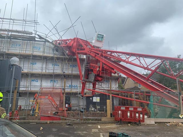 A crane has collapsed onto a house in east London