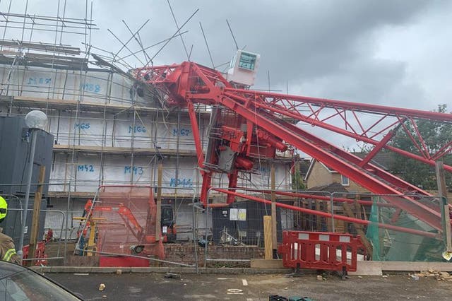 A crane has collapsed onto a house in east London