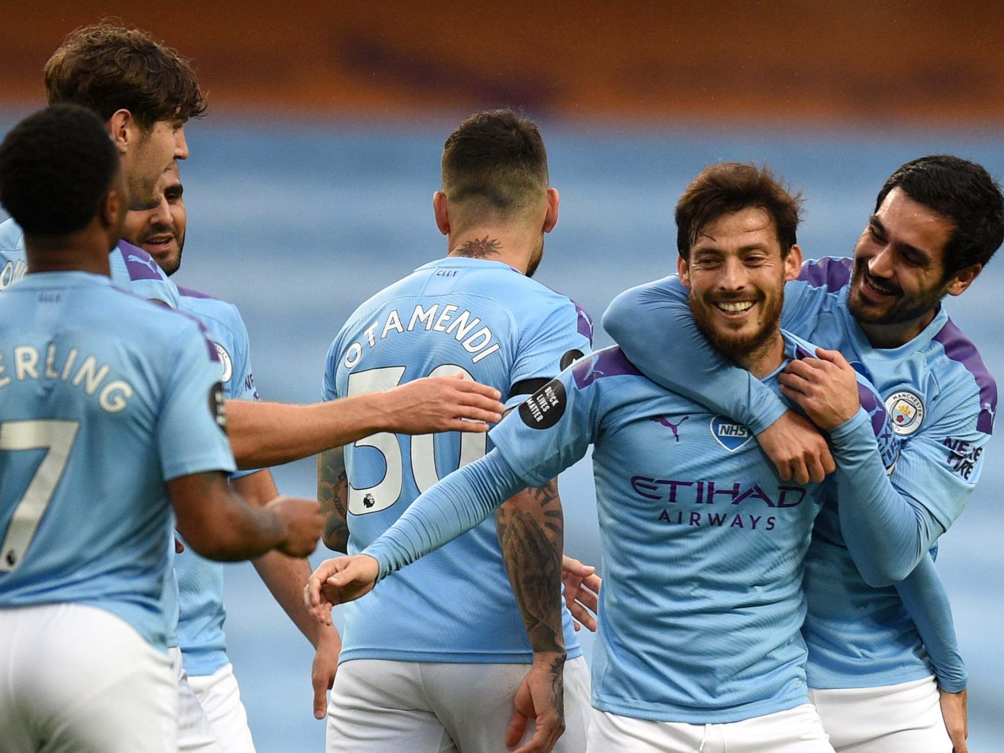 David Silva celebrates with teammates after scoring City's fourth
