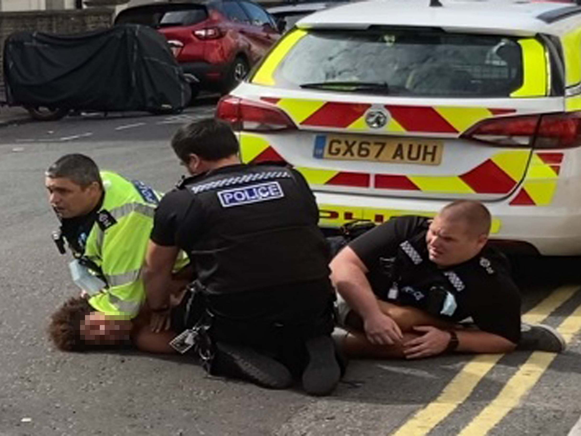 Sussex Police officers pin man on road as he shouts 'I can't breathe'