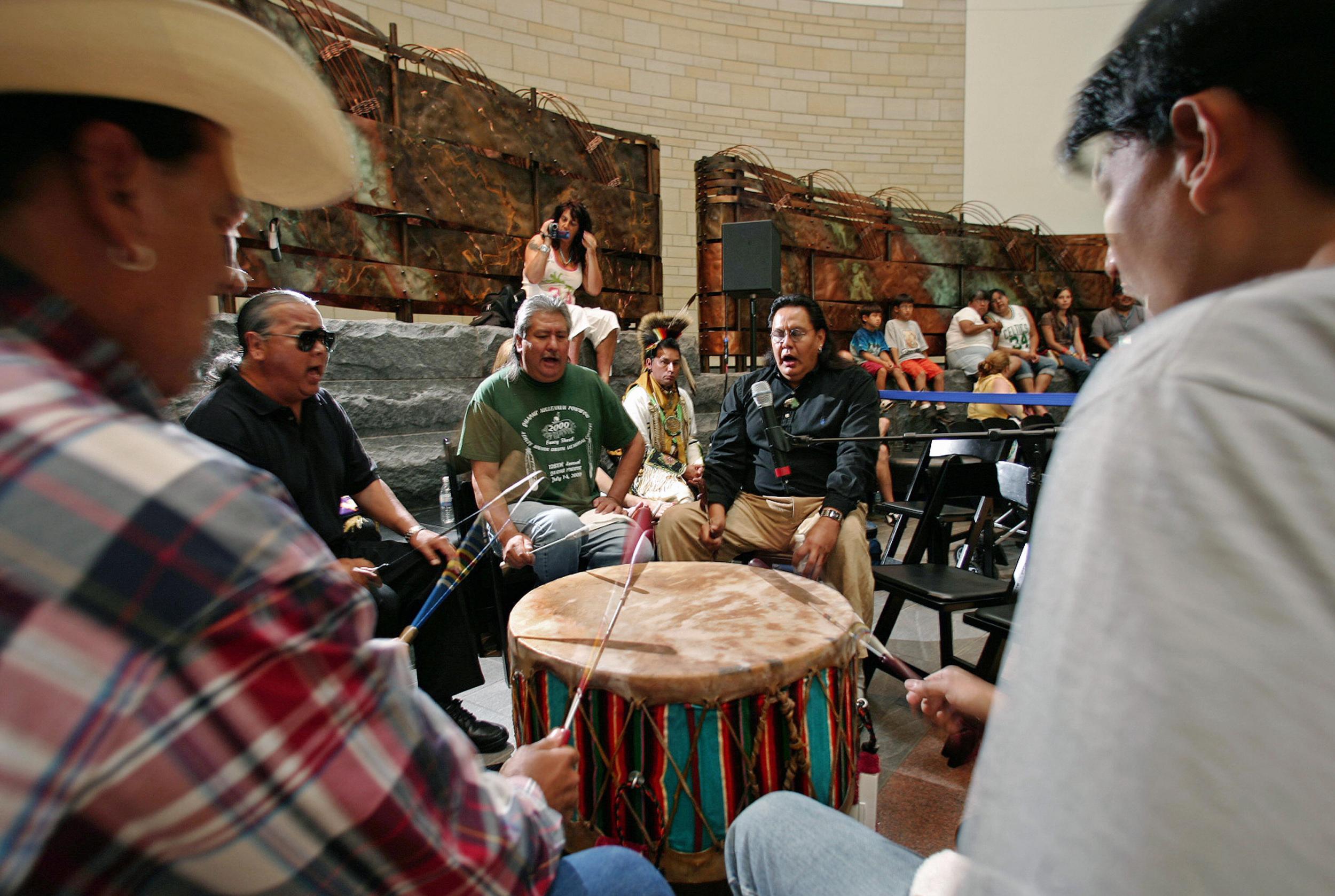Members of the Yellow Hammer Native American drum band from Ponca City, Oklahoma, play a song for Native American dancers inside the newly opened National Museum of the American Indian in Washington, DC in 2005