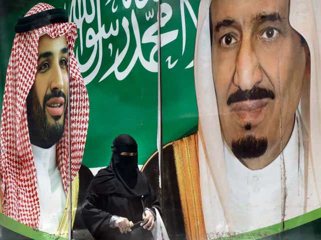 King Salman (right) and his son Mohammed bin Salman (left) on a poster in Riyadh, Saudi Arabia