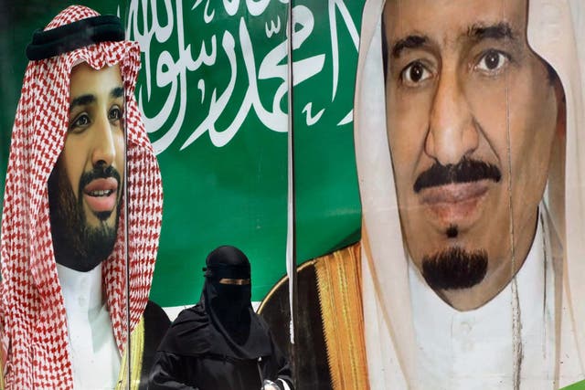 King Salman (right) and his son Mohammed bin Salman (left) on a poster in Riyadh, Saudi Arabia