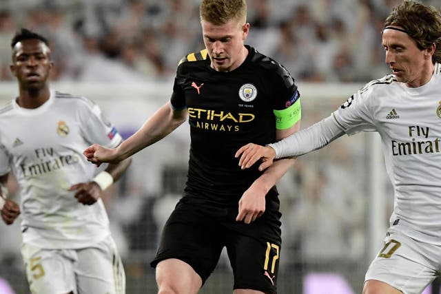 Manchester City midfielder Kevin De Bruyne vies with Real Madrid's midfielders