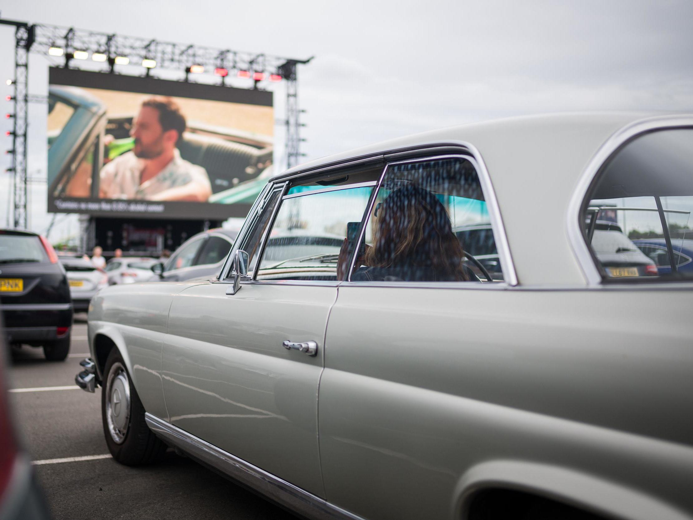 Audience members wait to watch live comedy from Dom Joly at the Drive-In Club venue in London on 3 July, 2020