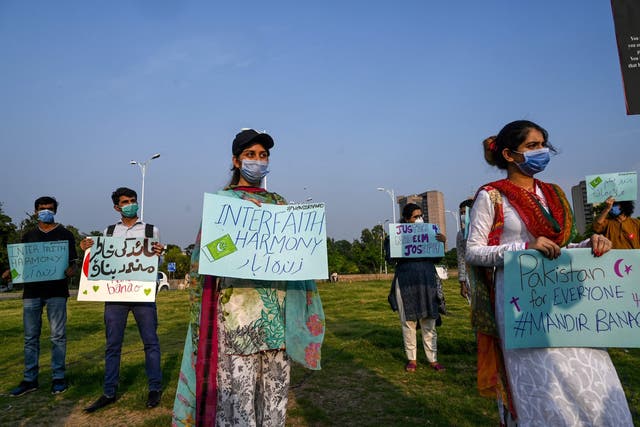 Demonstrators hold placards during a protest in support of the Islamabad temple's construction on Wednesday 8 July