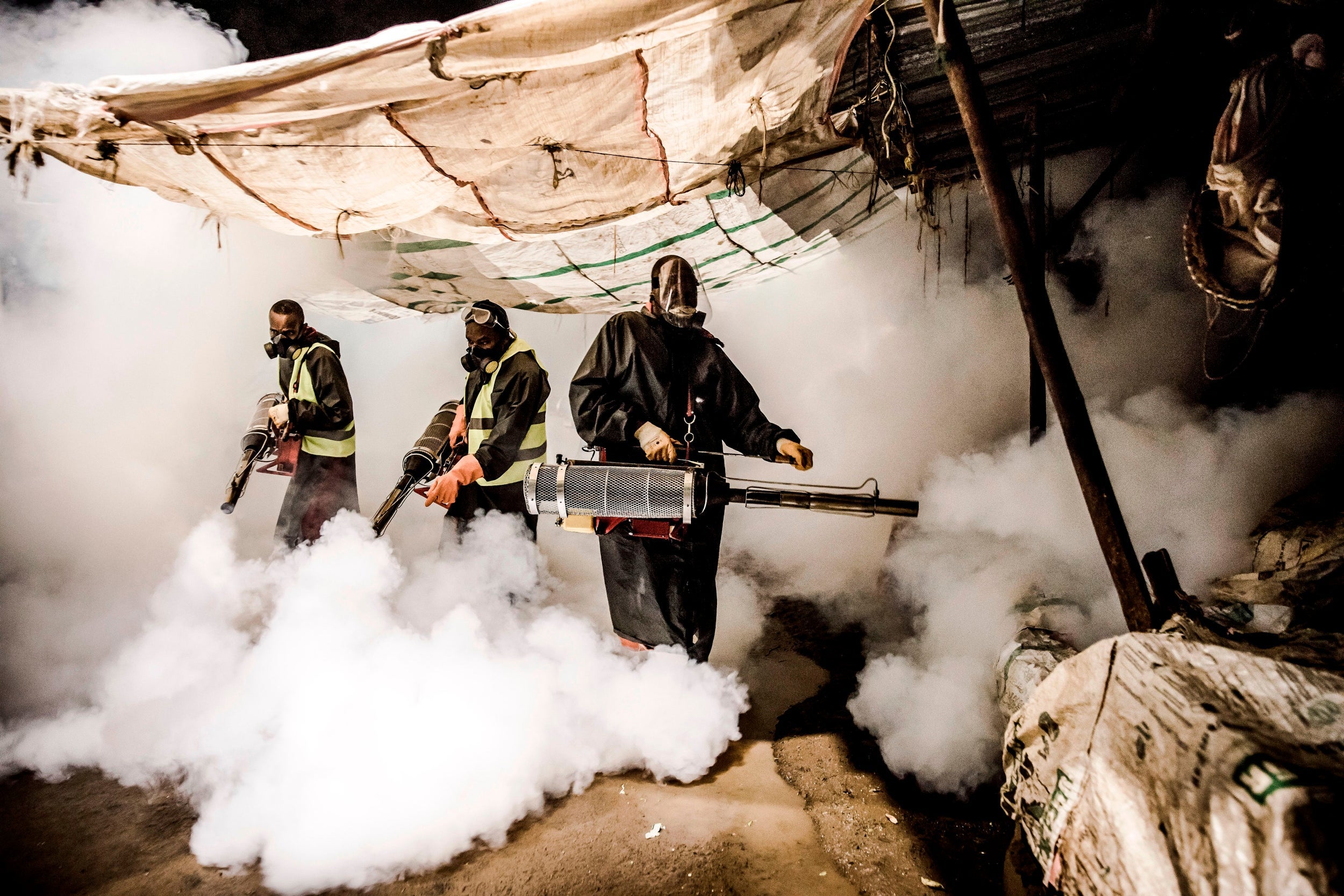 Members of a privately funded NGO fumigate a market in Nairobi