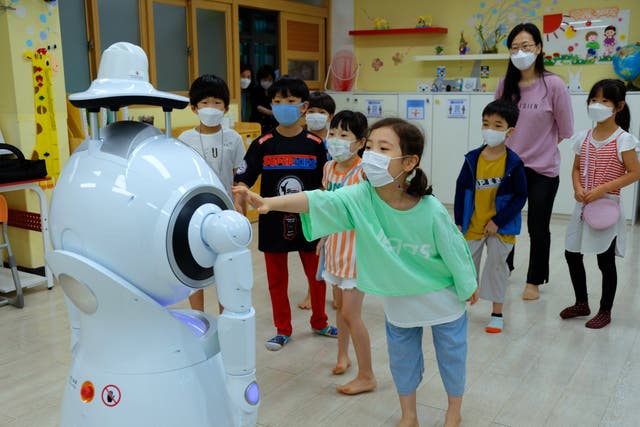 Students practise dance moves with a robot at Wooam Elementary School in Seoul