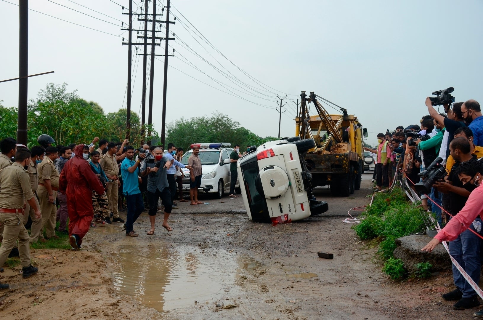The overturned vehicle that was carrying Vikas Dubey is towed away near Kanpur on Friday