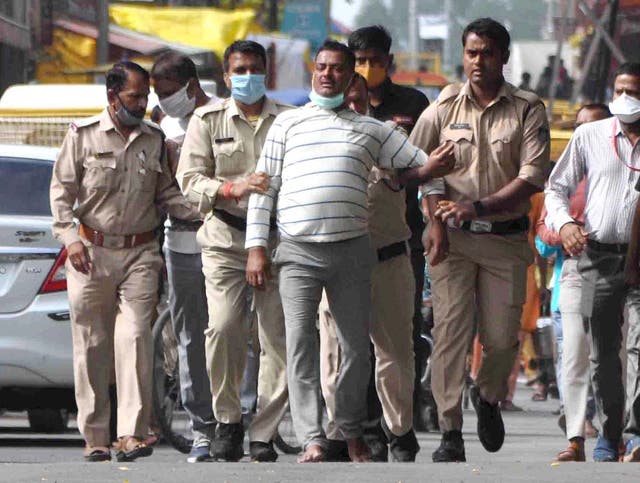 Suspected crime boss Vikas Dubey is pictured after handing himself in to Madhya Pradesh police on Thursday. Less than 24 hours later he was shot dead