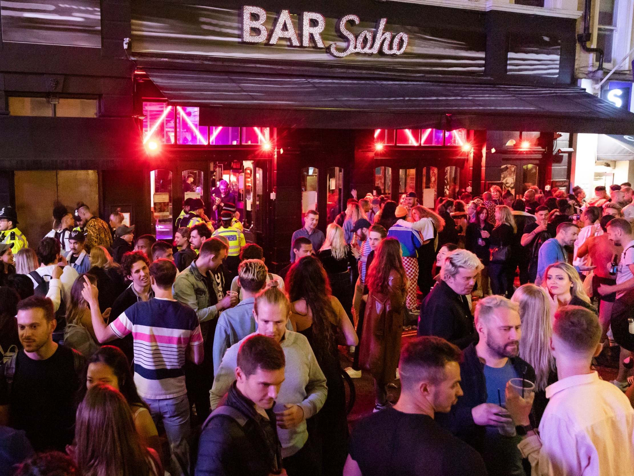 Revellers drink and socialise in the street in Soho, London, 4 July 2020.