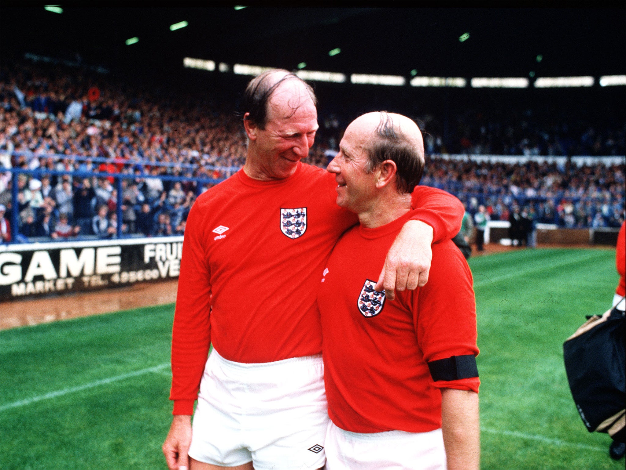 The Charlton brothers, Jack and Bobby, embrace at the end of a charity match at Elland Road, Leeds, in 1985
