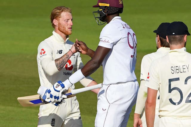 Jason Holder is congratulated by Ben Stokes