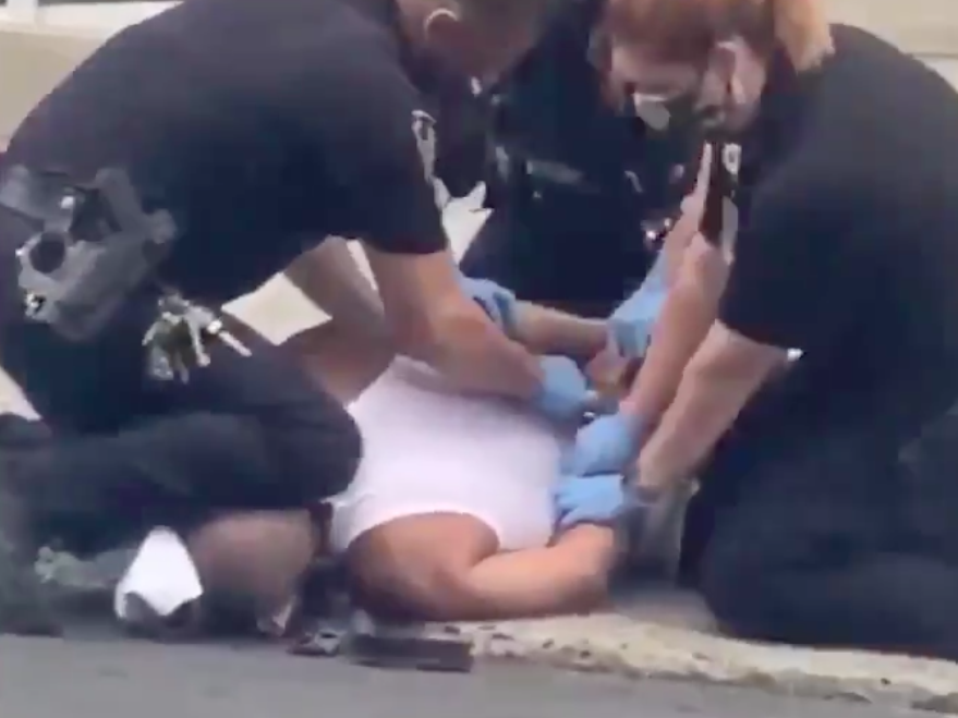 A police officer kneels on a man who was reportedly behaving "erratically" outside a hospital in Allentown, Pennsylvania