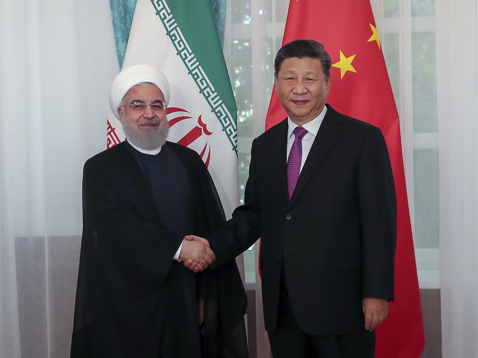 Partnership has been approved by the government of president Rouhani [left], pictured here meeting with Xi Jinping last year