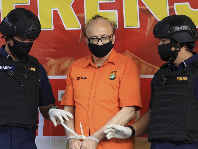 French national Francois Camille Abello flanked by police officers at a press conference in Jakarta, Indonesia, on 9 July, 2020.