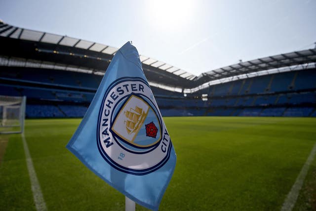 The corner flag is backdropped by a general view of the Etihad stadium