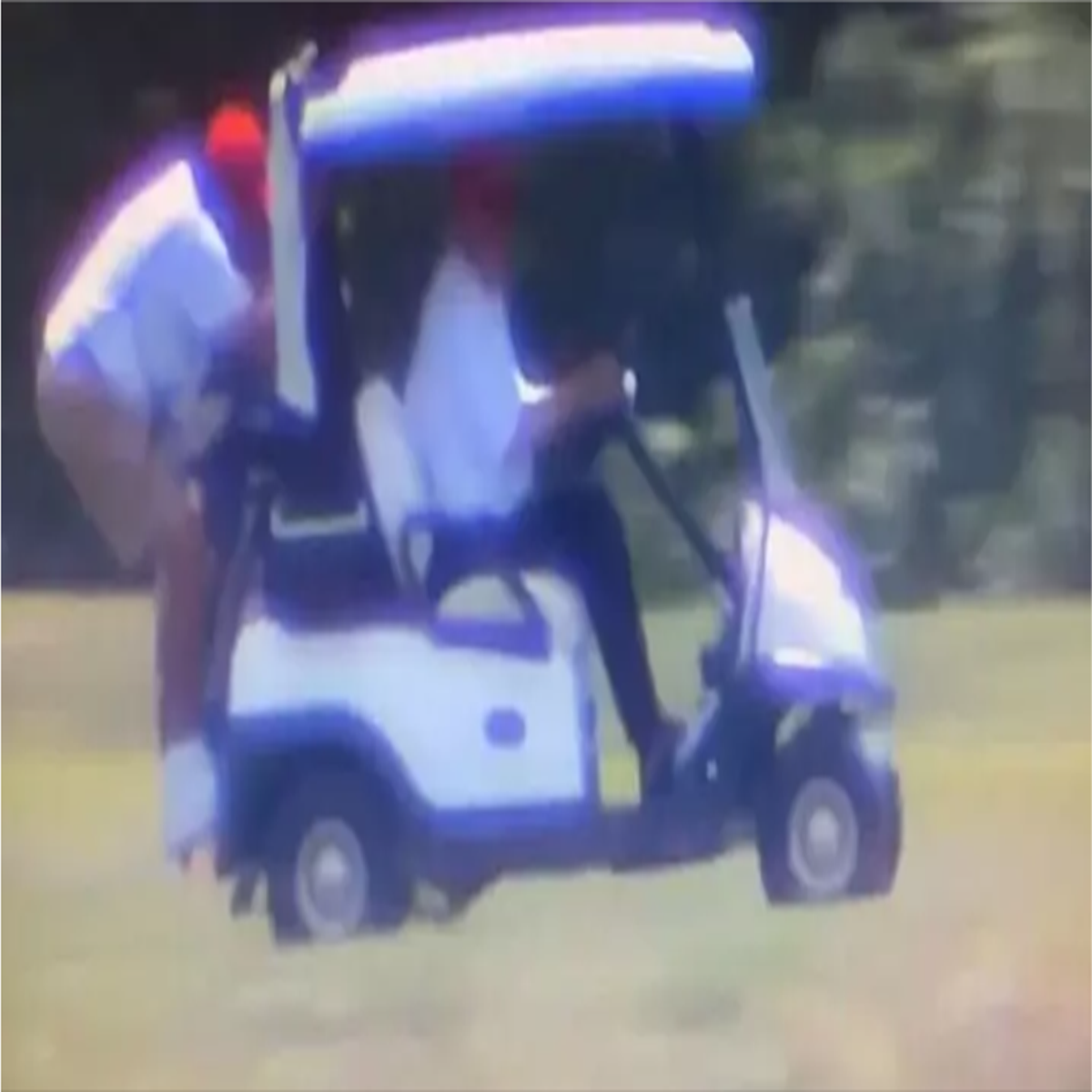 Donald Trump drives golf cart with caddie hanging off the back | The  Independent | The Independent