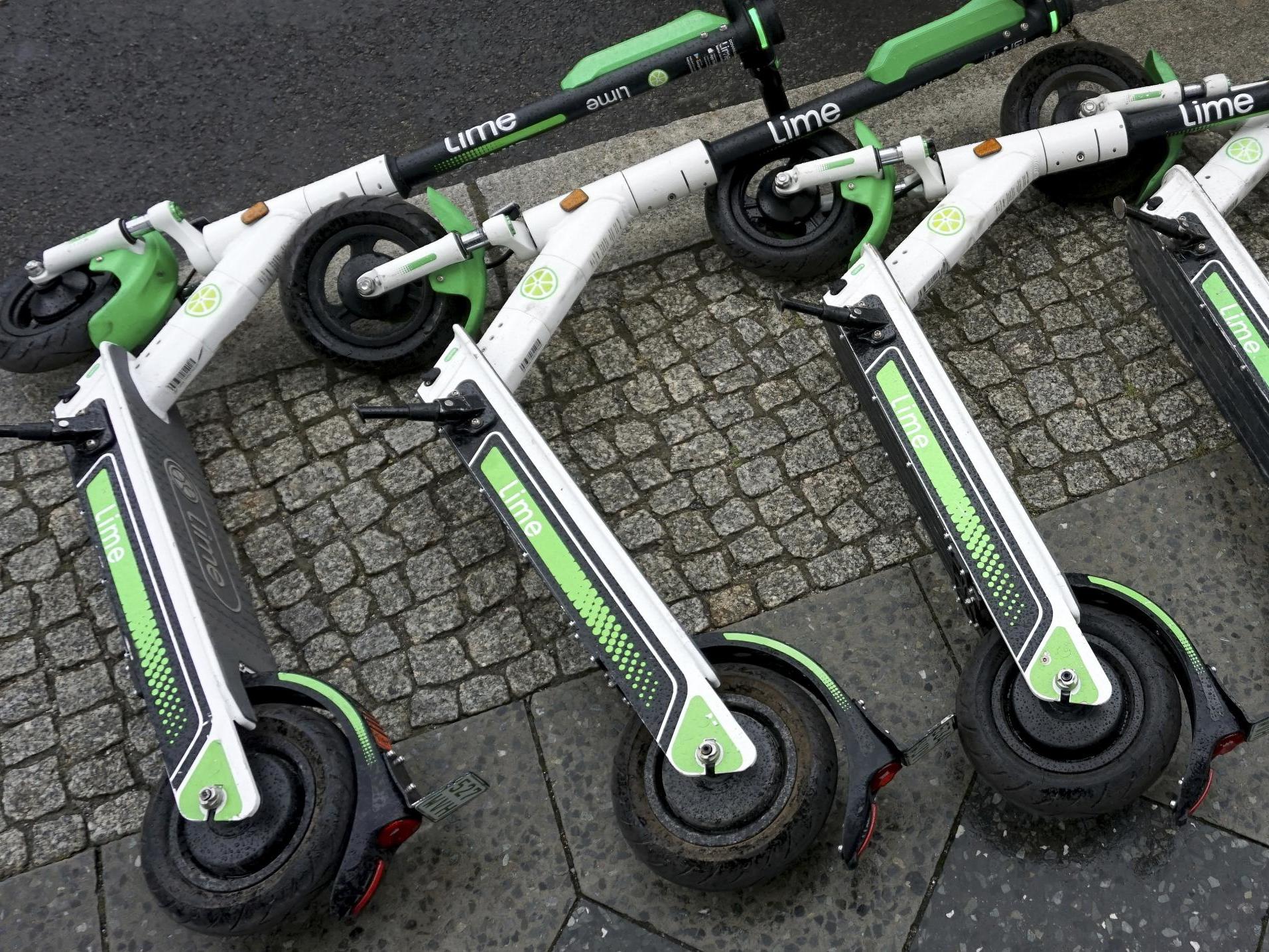 Rental e-scooters lie on a pavement in Berlin, Germany