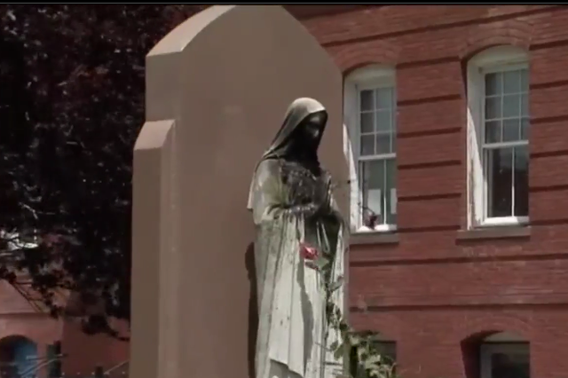 The vandalised statue of the Virgin Mary outside the Saint Peter’s Parish church in Dorchester, Boston