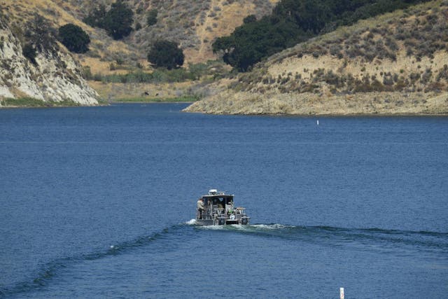 A Los Angeles County Sheriff's Department boat is seen on Lake Piru as it aids in the effort to find actor Naya Rivera on 10 July 2020 in Lake Piru, California.