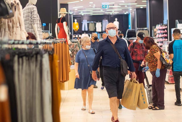 File photo of customers wearing face masks as they shop at Primark in Oxford Street, London.