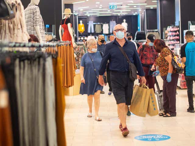 File photo of customers wearing face masks as they shop at Primark in Oxford Street, London.